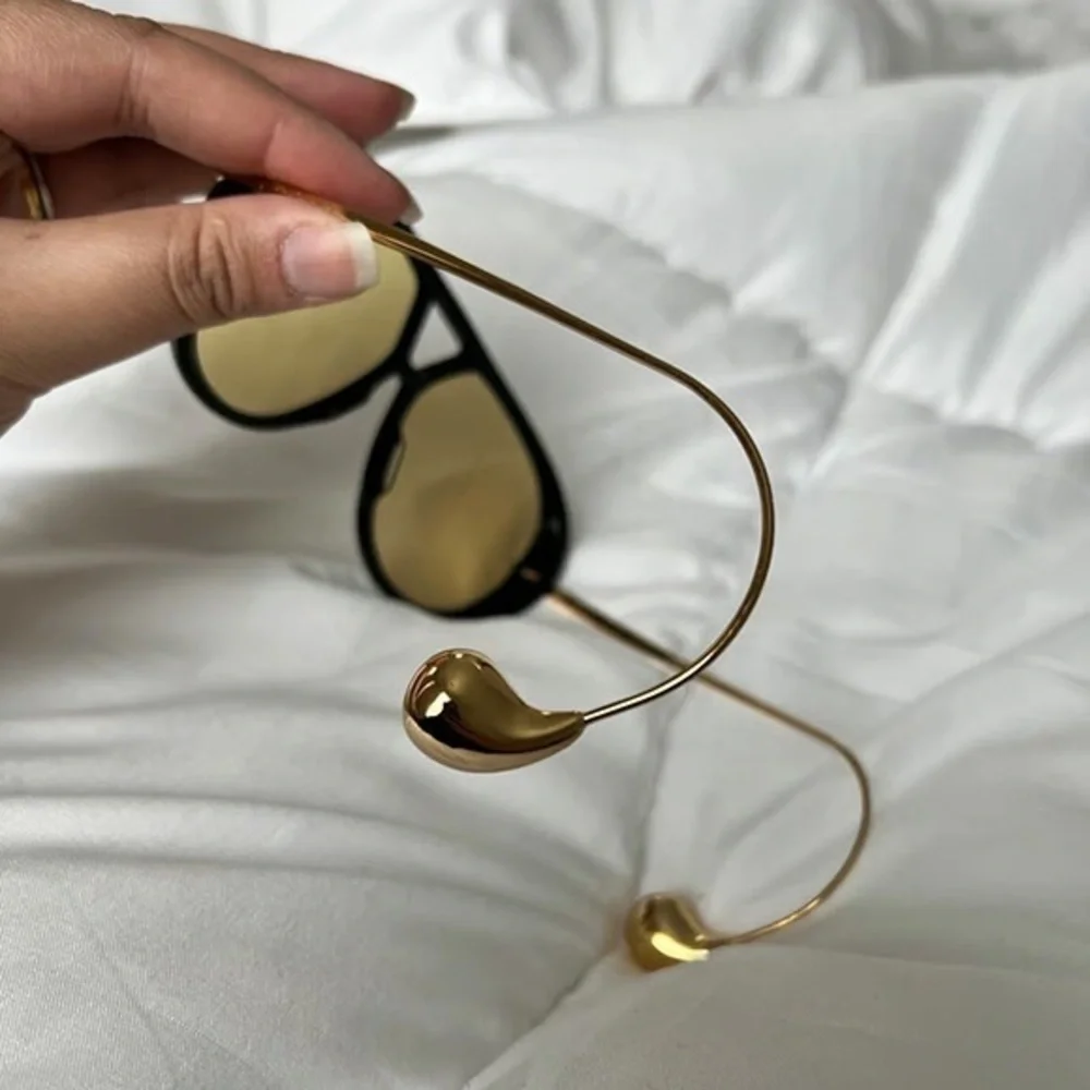 Bottega Veneta Black Frame Sunglasses with Yellow Lenses